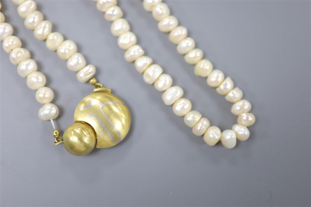 A modern single strand baroque pearl necklace, with yellow metal clasp, 45cm, gross 51.7 grams.